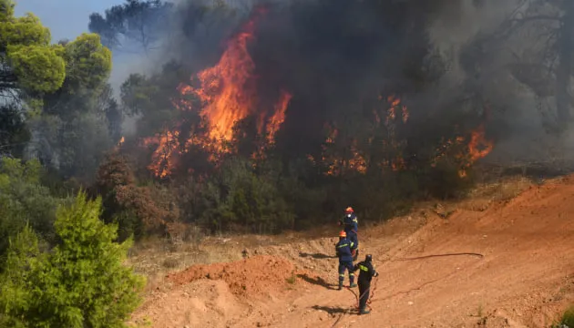 Fires near Athens have destroyed nearly 100 homes in Greece