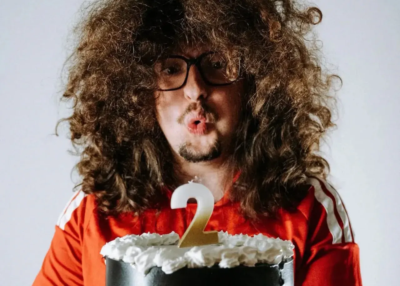 A Manchester United fan hasn't had a haircut in two years in hopes of winning five titles