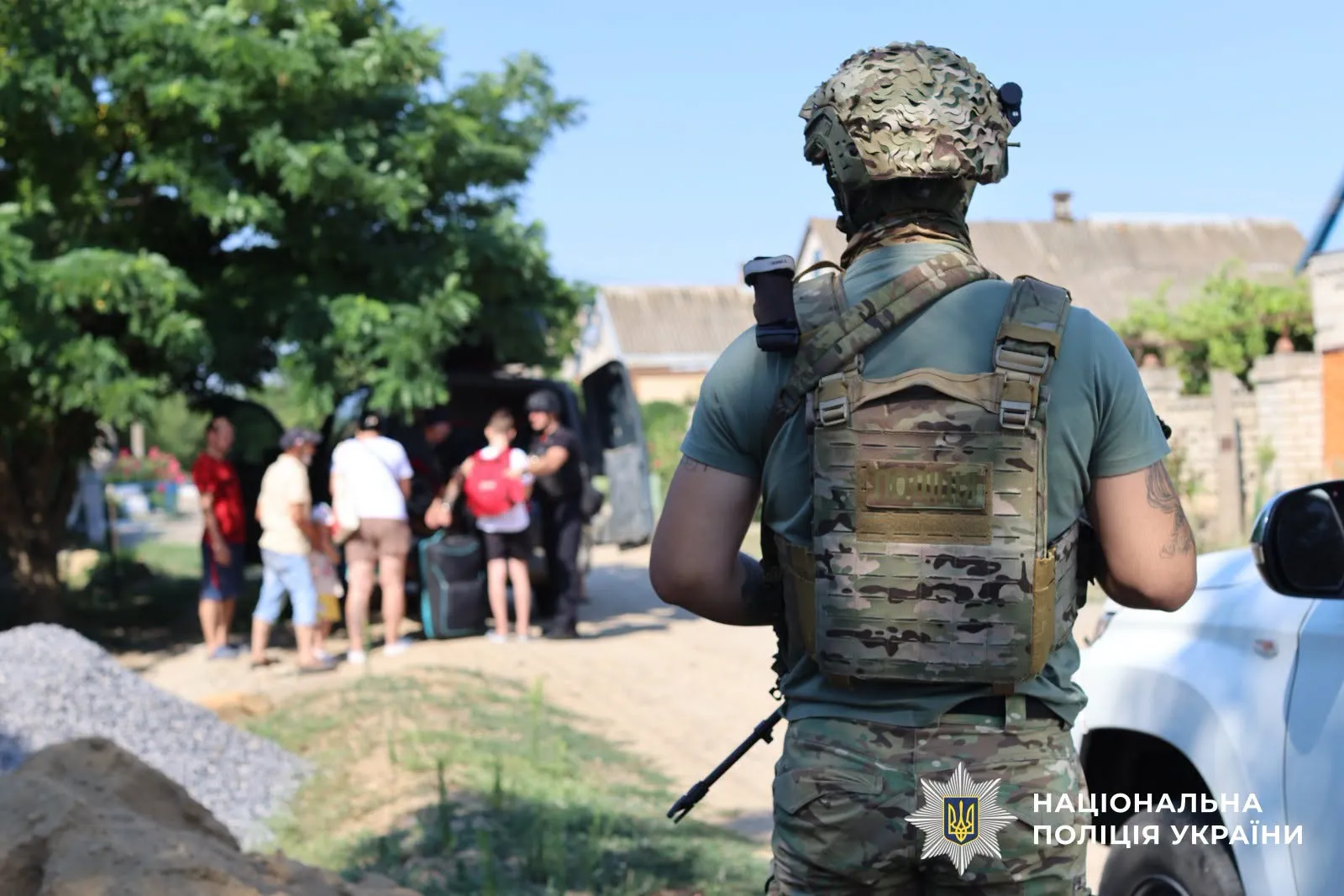 Police officers and volunteers evacuated a mother and her three children from an area under shelling in the Kherson region