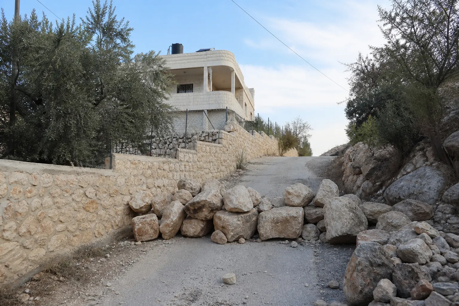 Israeli settlers are blockading two Palestinian families in the West Bank